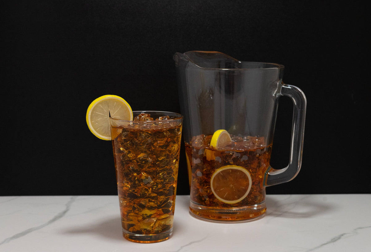 Fake iced tea pitcher — side view showing amber resin fill level and pitcher handle
