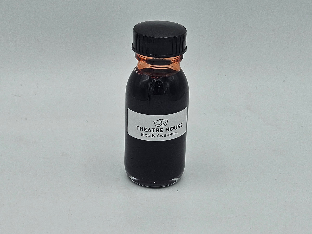 Stage Blood 2oz glass bottle — deep red theatrical blood, close-up