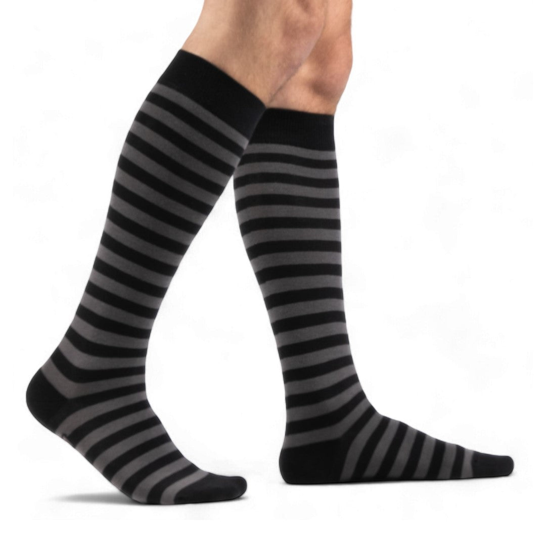 Smoke grey and black striped knee high socks — male model seated, side view