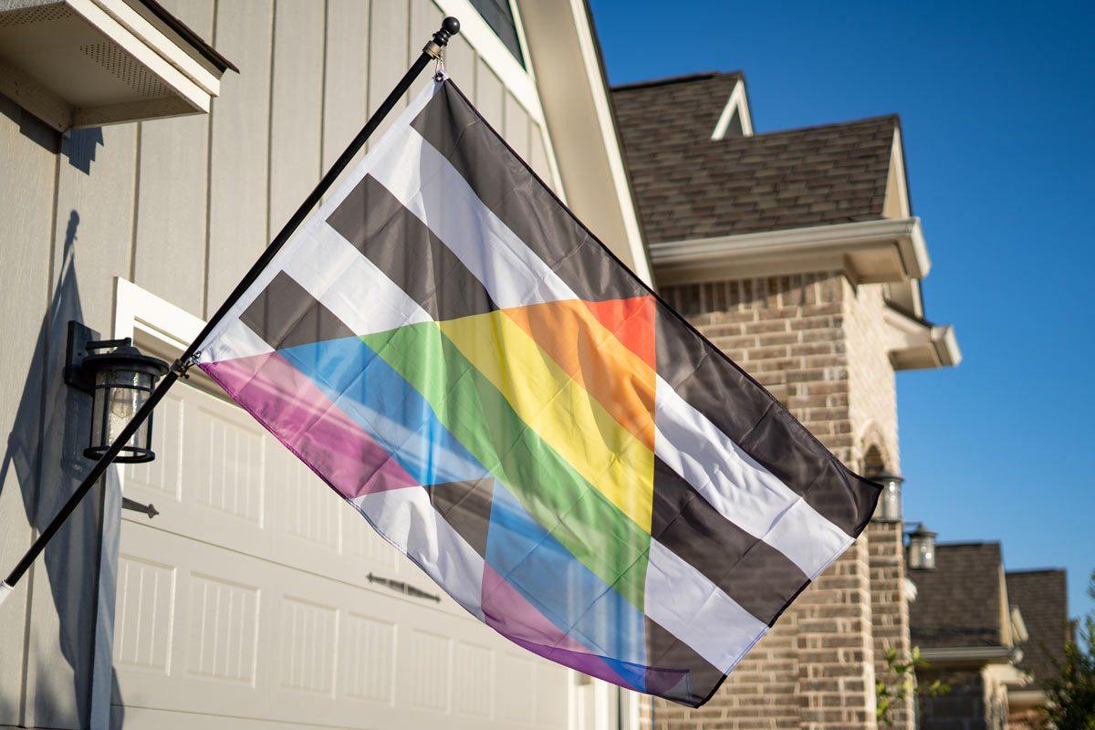 LGBTQ Ally flag flying on a flagpole outdoors