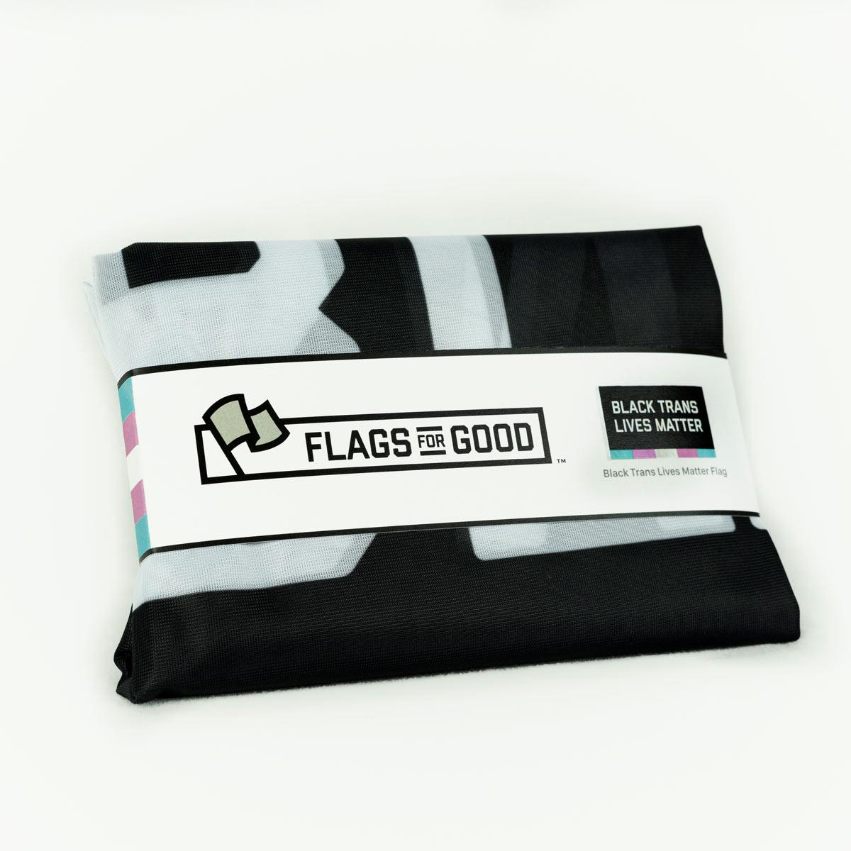 Black Trans Lives Matter flag — folded, showing grommets and stitched edges