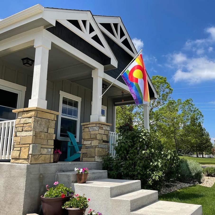 Rainbow Colorado Pride Flag flying outdoors on a pole