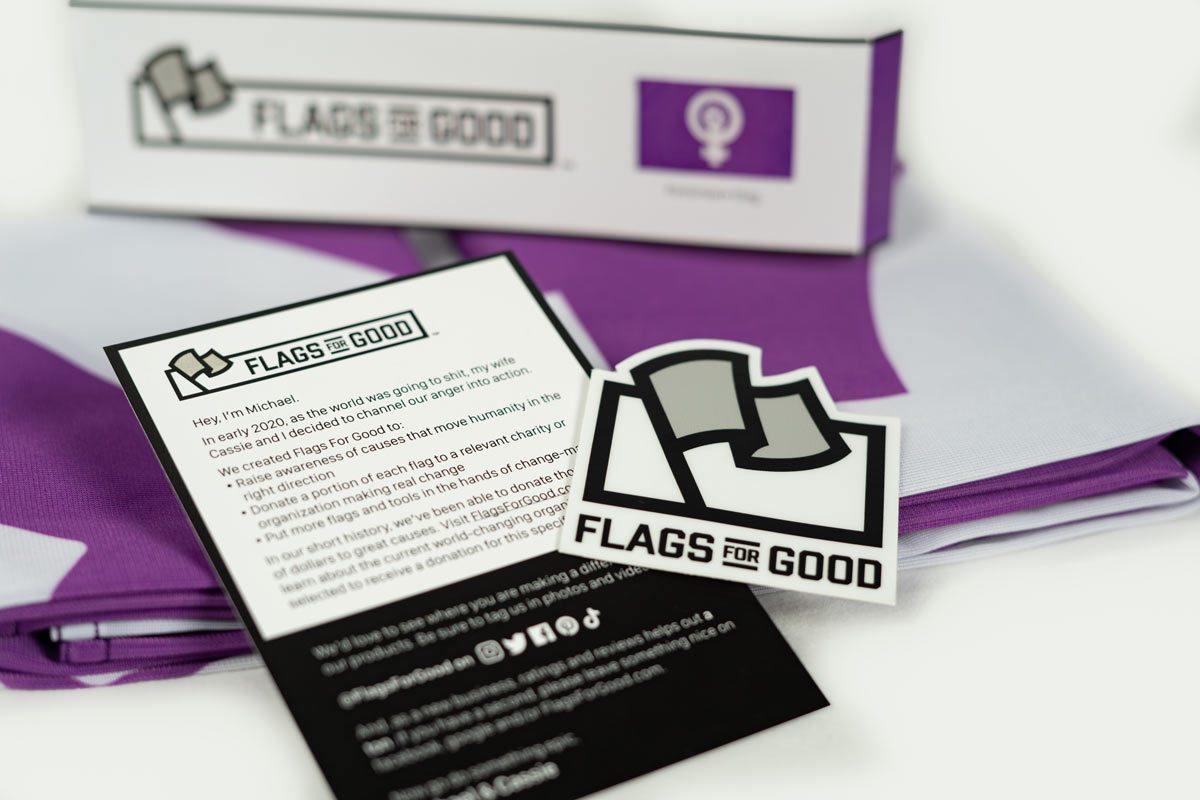 Feminism Flag — unfolded flat lay showing full purple design
