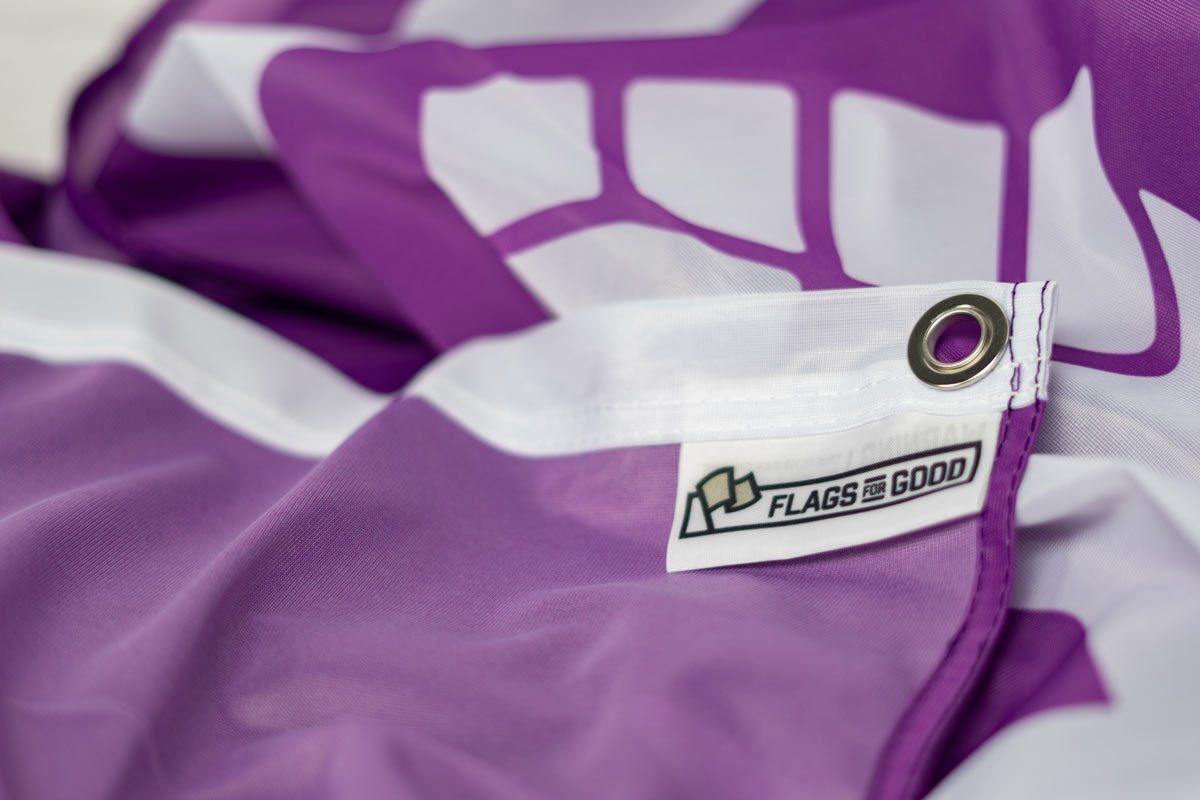 Feminism Flag — close-up of tag showing quality and care details
