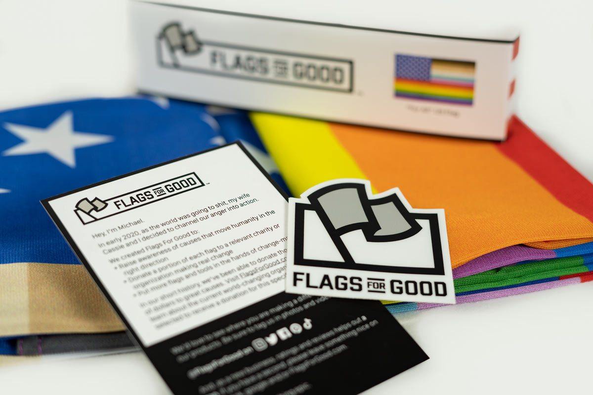 "For All" rainbow US flag unfolded flat, full design visible