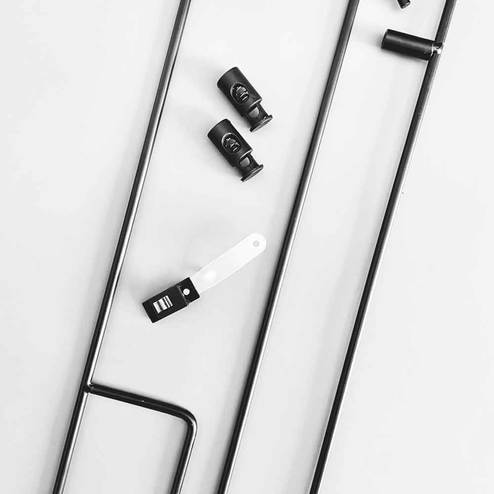 Garden flag pole — close-up of cinch clips and bottom attachment hardware