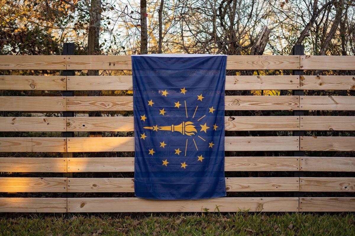 Indiana Flag displayed on fence outdoors