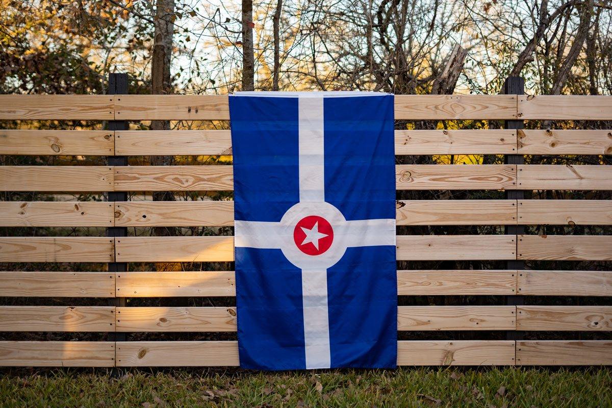 Indianapolis flag displayed on a fence outdoors