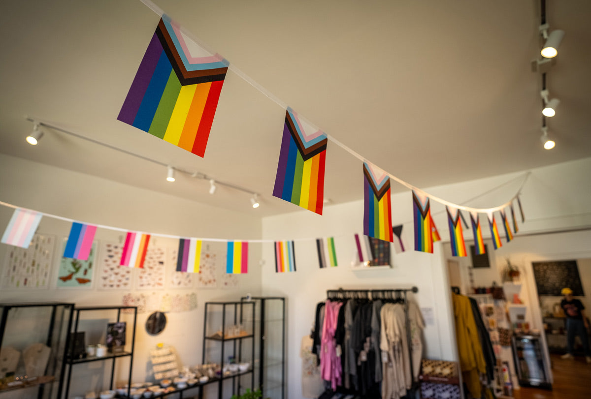 Progress Pride bunting displayed in store, full strand in-use view