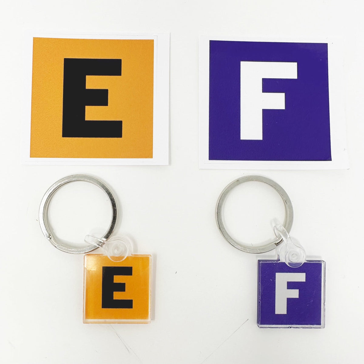 Last Look Labels vehicle key fobs — orange and purple variant pair