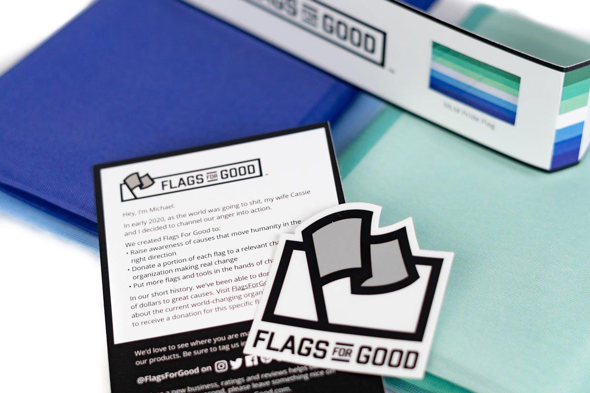 MLM Pride Flag unfolded flat lay showing full seven-stripe design
