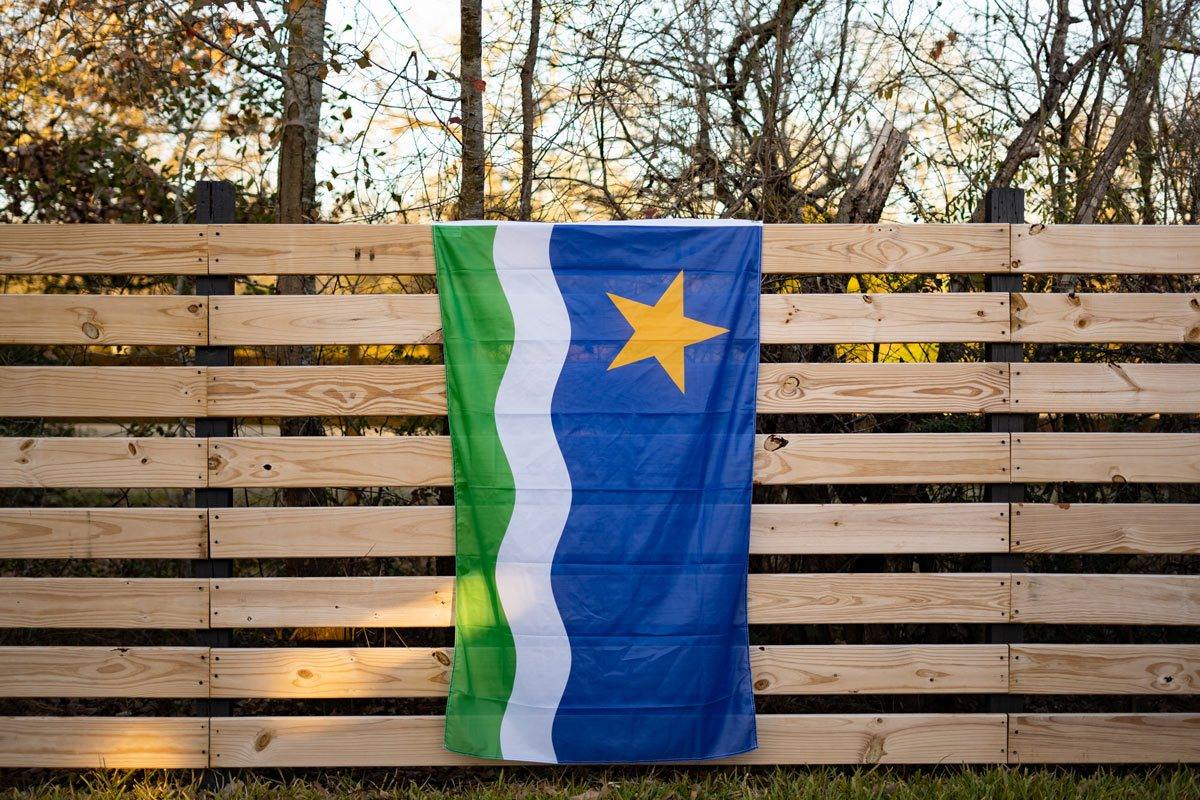 Minnesota North Star Flag displayed on fence outdoors