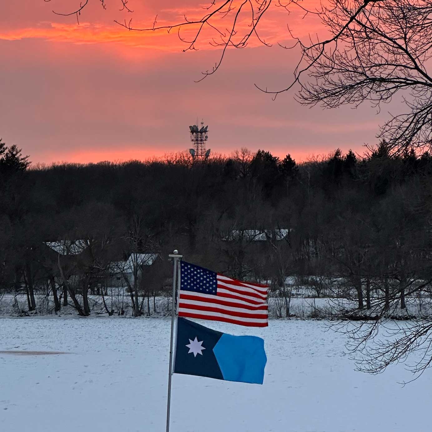 New Minnesota State Flag flying outdoors at sunset