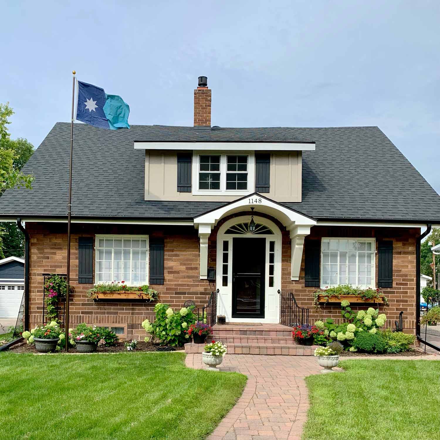 New Minnesota State Flag flying outdoors on a flagpole