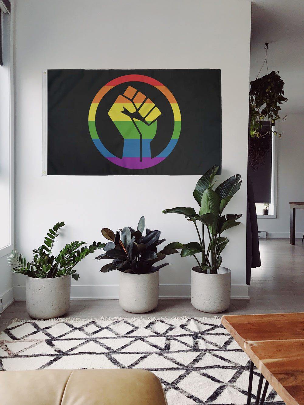 Rainbow Pride Fist flag displayed as wall hanging indoors
