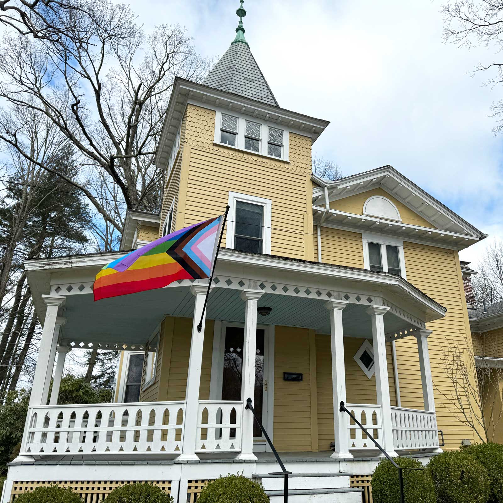 Large Progress Pride Flag flying outside a house