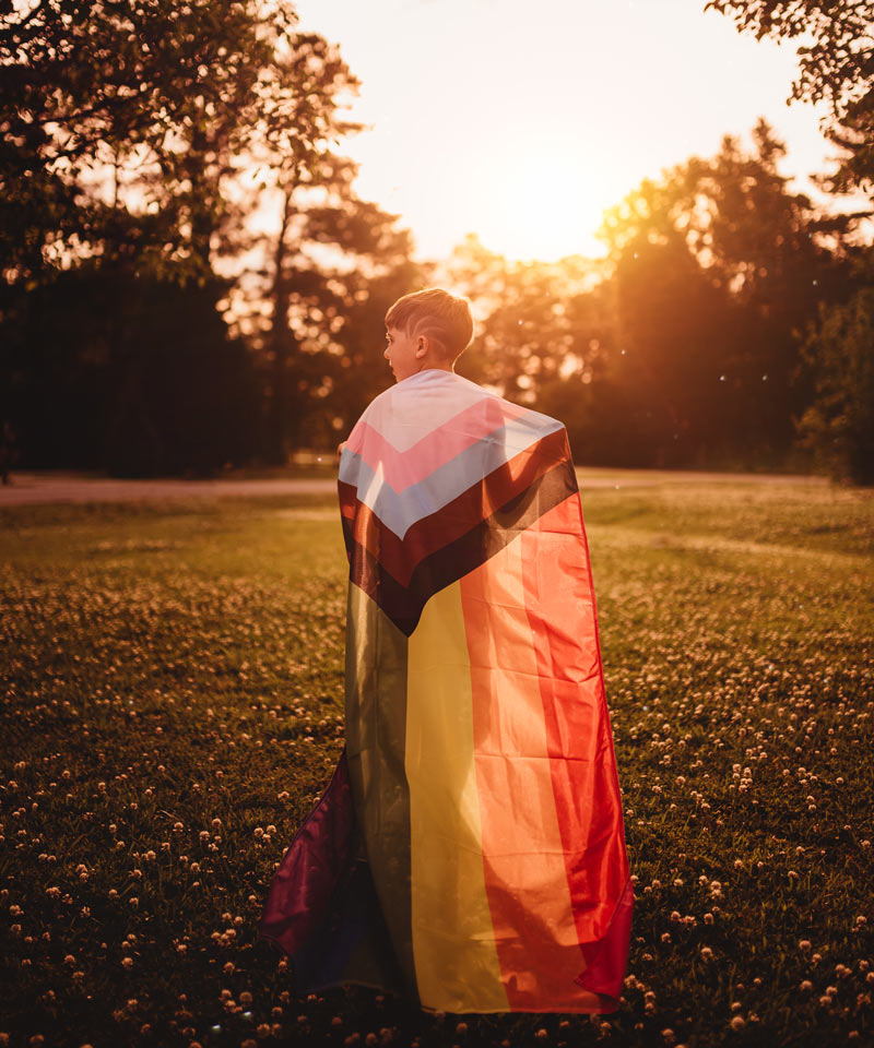 Progress Pride Flag flying outdoors at sunset