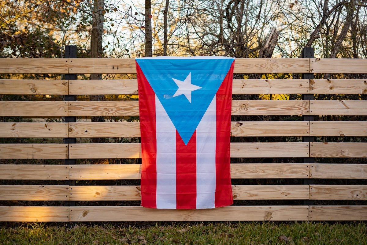 Puerto Rico light blue flag displayed on a fence