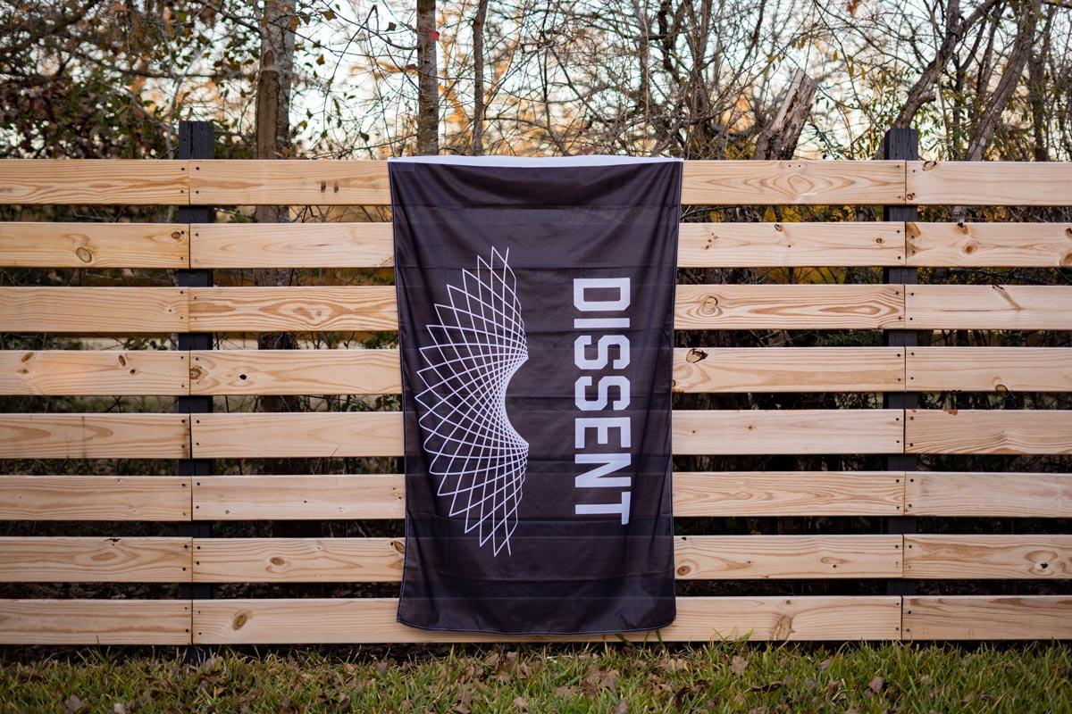 RBG Dissent flag displayed on a fence outdoors