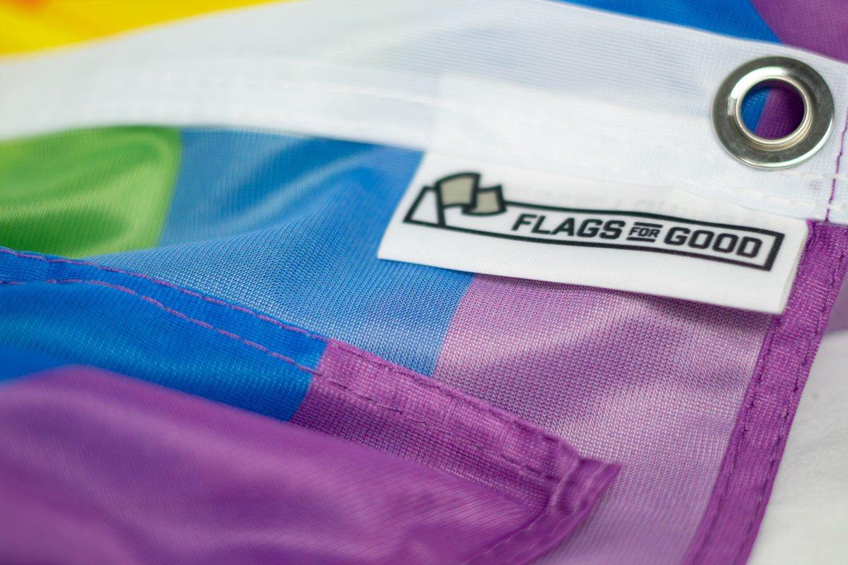Rainbow Pride flag — close-up of product tag and grommet detail