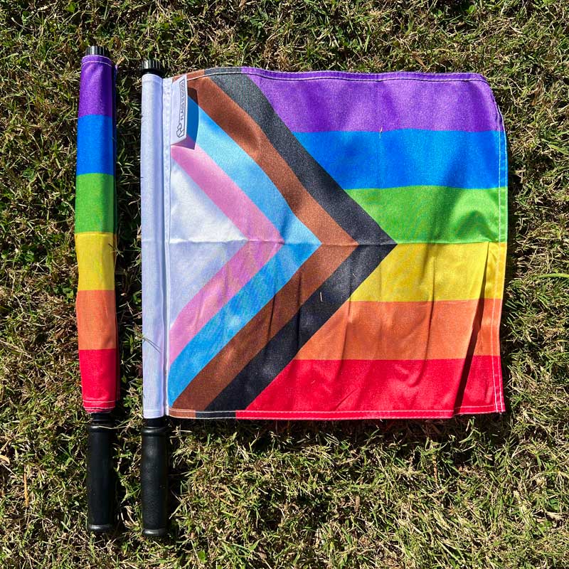 Progress Pride referee flags — open and closed position example showing pole pocket