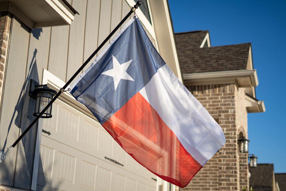 Texas flag flying on a flagpole outdoors