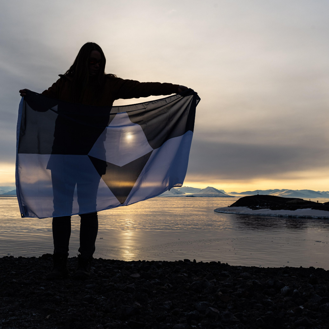 True South Antarctica flag displayed against a sunset sky