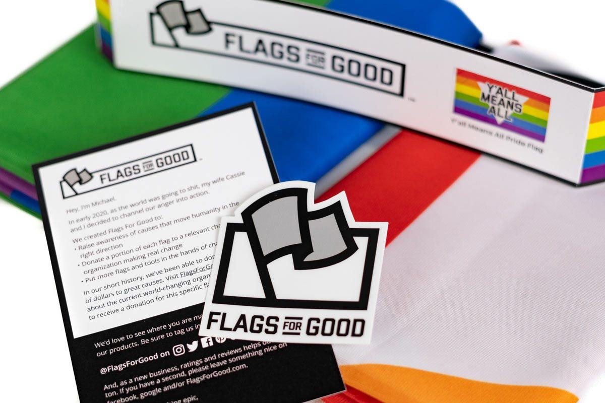 Y'all Means All rainbow flag unfolded flat, full design visible