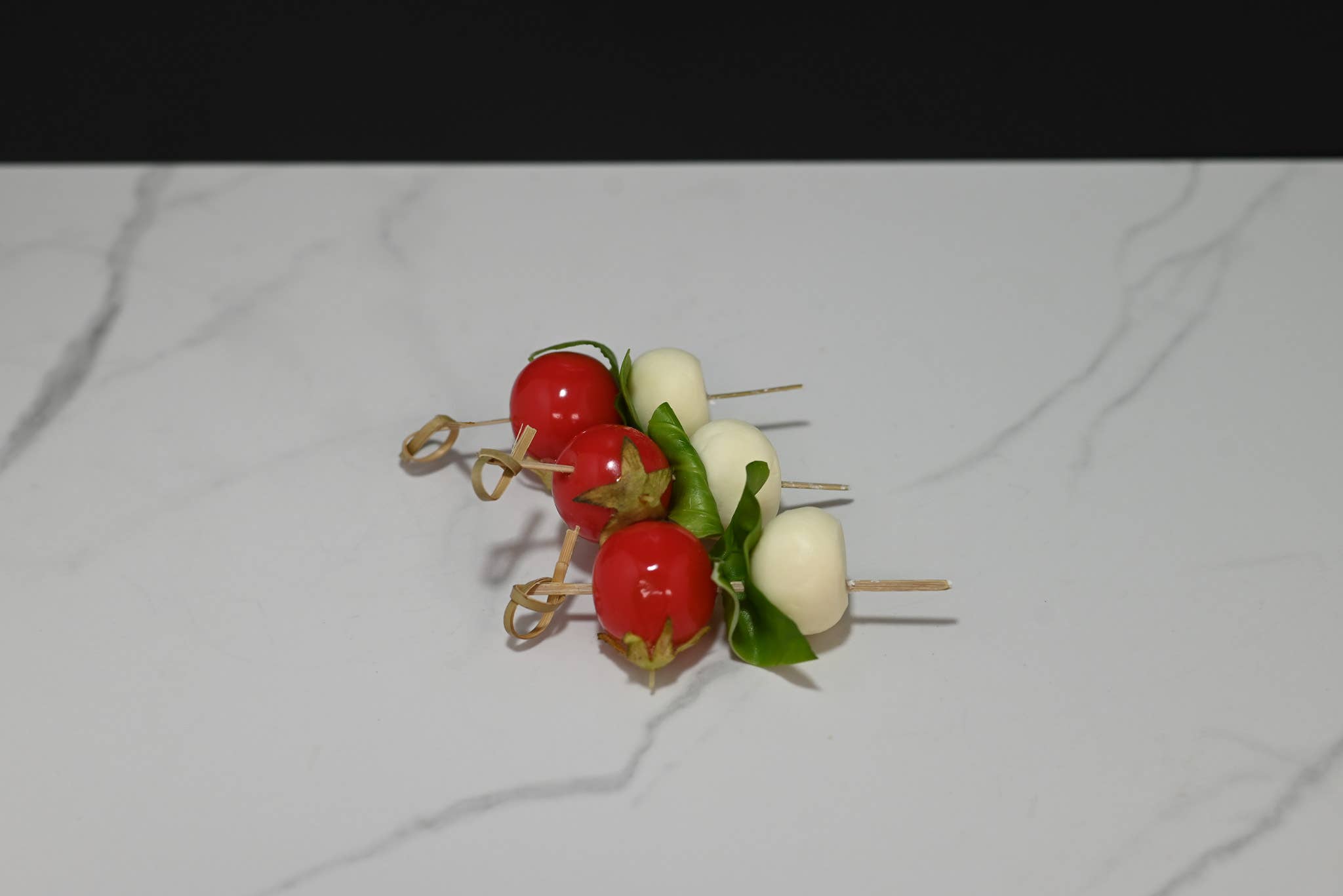 Fake caprese skewers — overhead view showing all 3 skewers with tomato, mozzarella, and basil