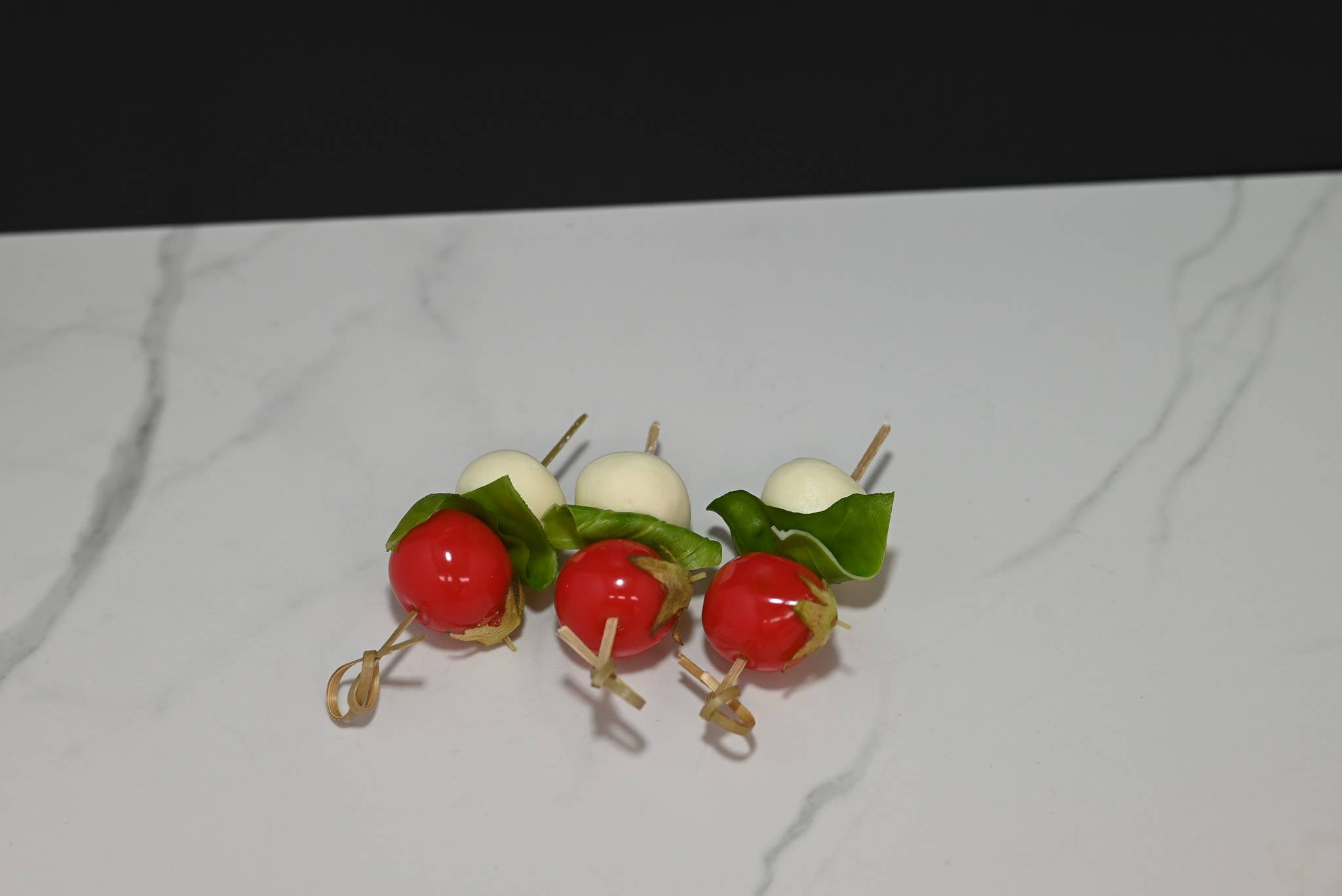 Fake caprese skewers styled in decorative display arrangement