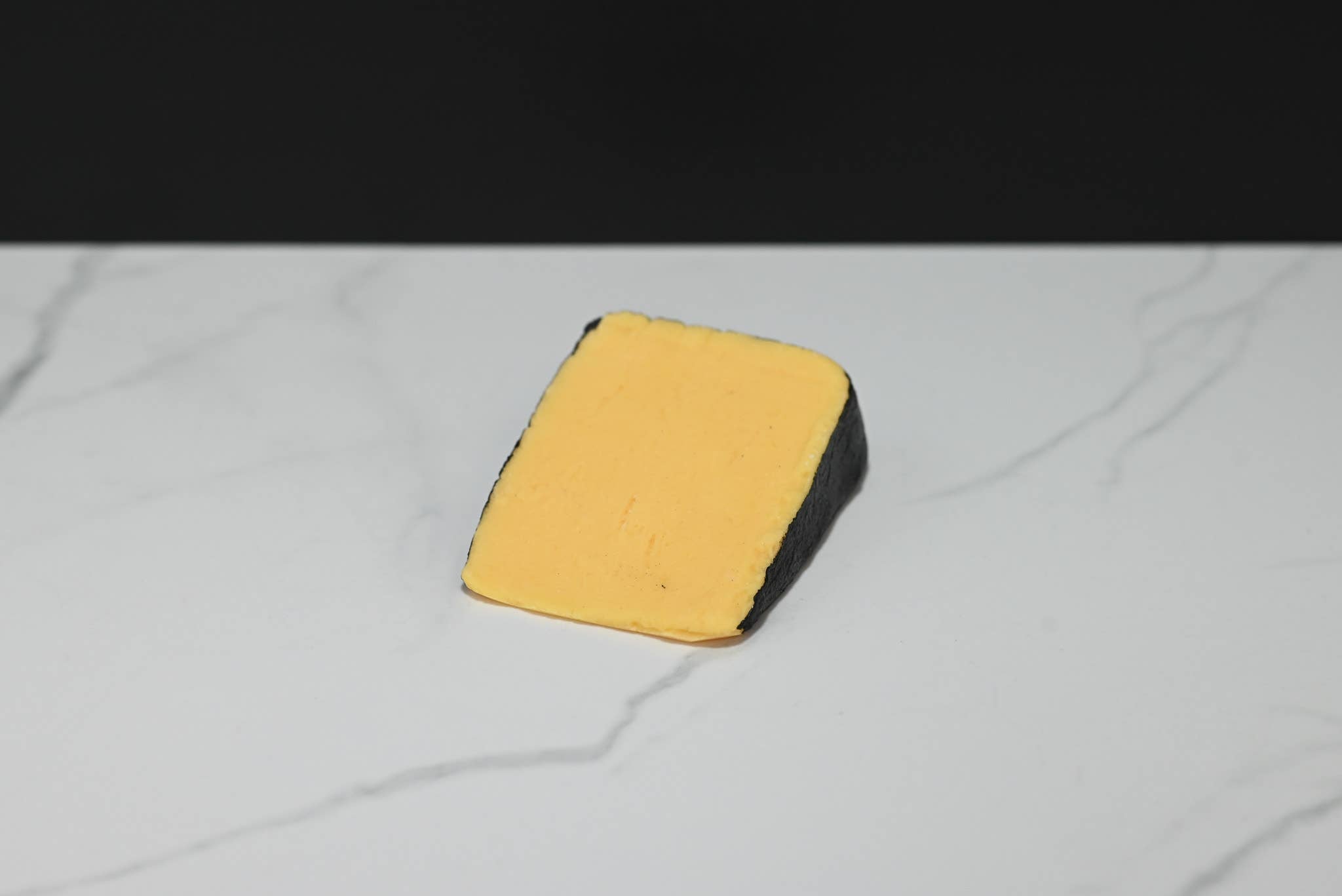 Fake cheddar cheese wedge — top-down view on charcuterie board display