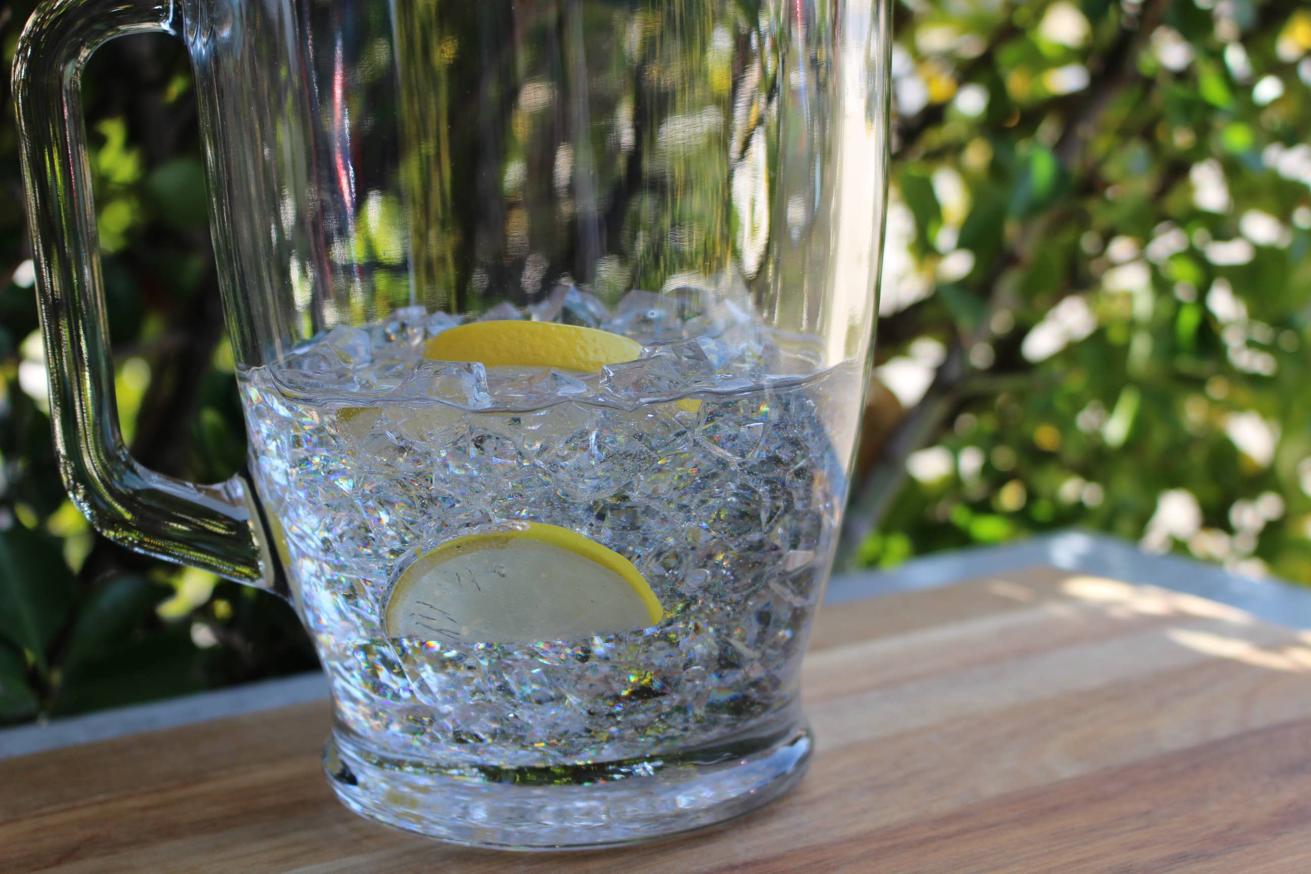 Fake iced water pitcher — side view showing clear resin water and lemon slices, approx 11"×7"