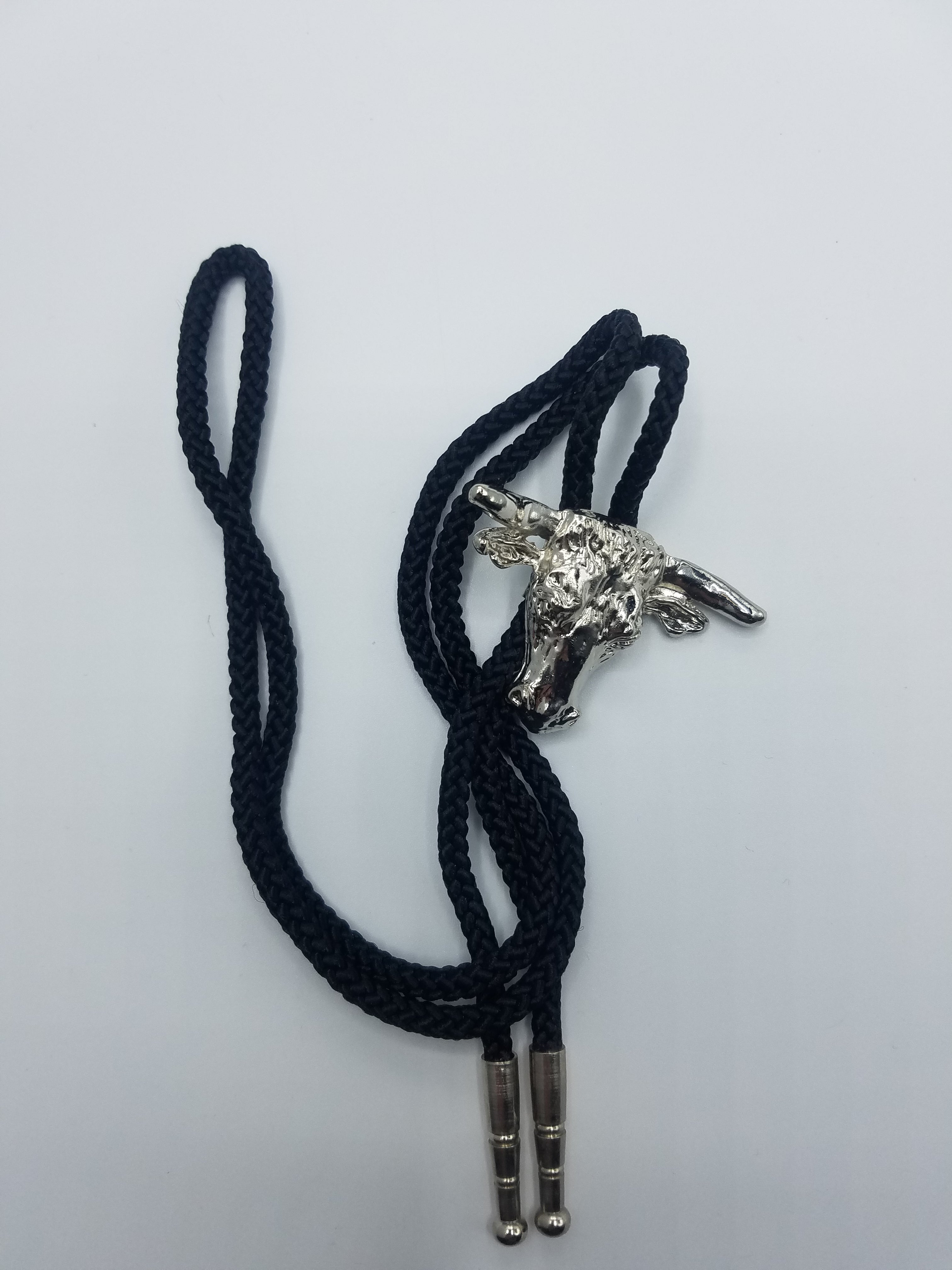 Western bolo tie — black cord, silver cowboy boot slider, metal tips, 37"L