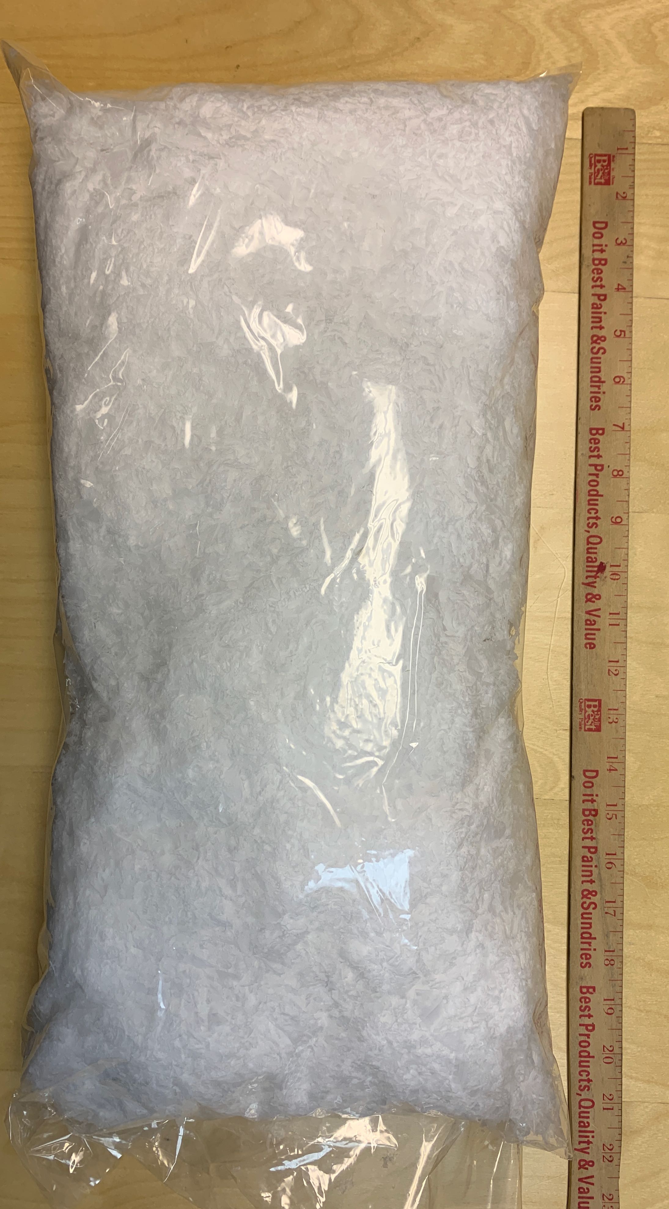 Large bag of artificial snow flakes next to a ruler